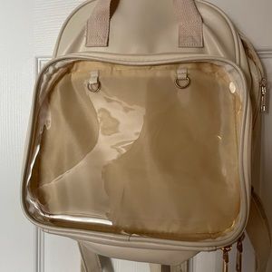 Ita style cream colored backpack purse.